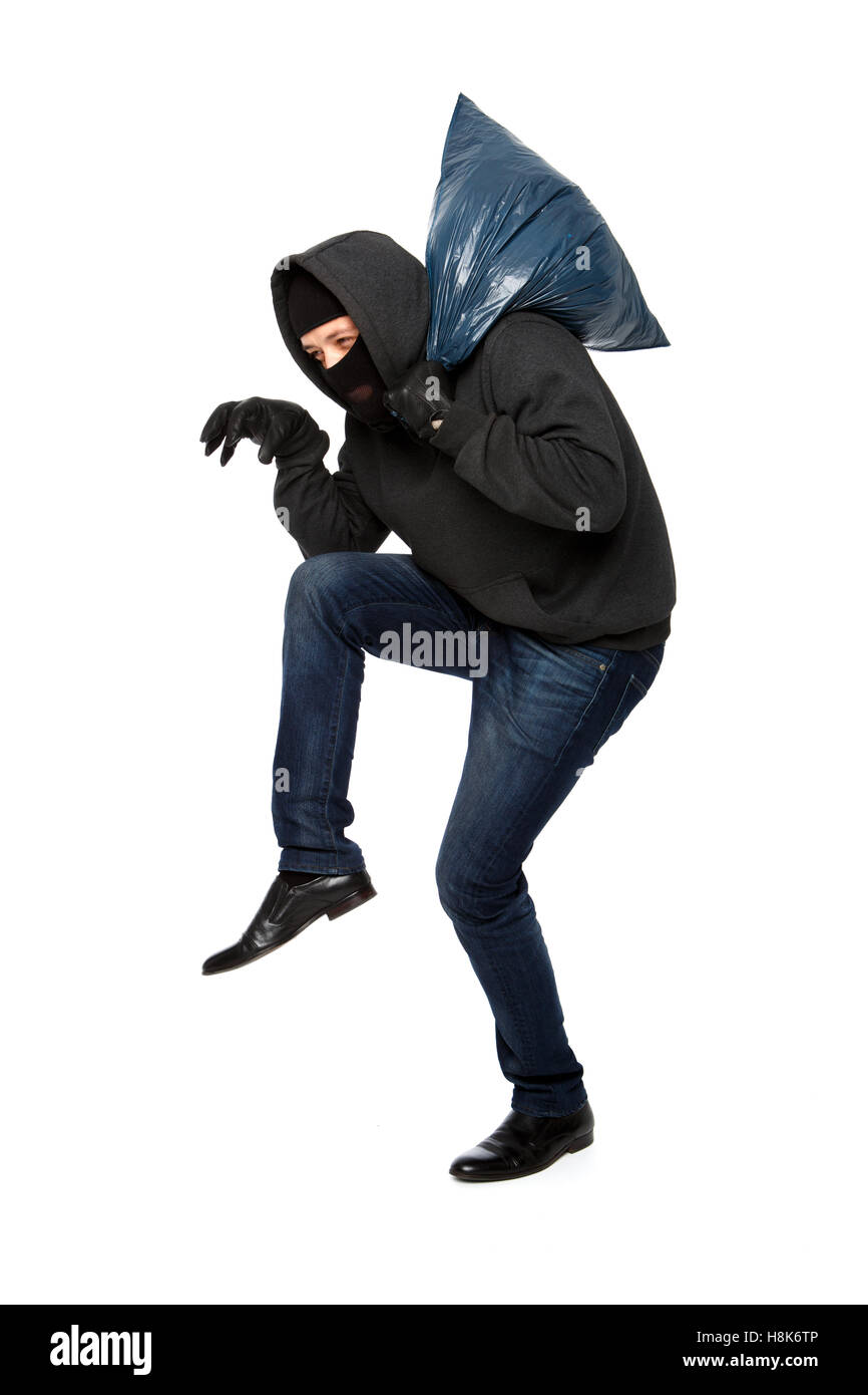 Robber sneaks in black mask Stock Photo Alamy