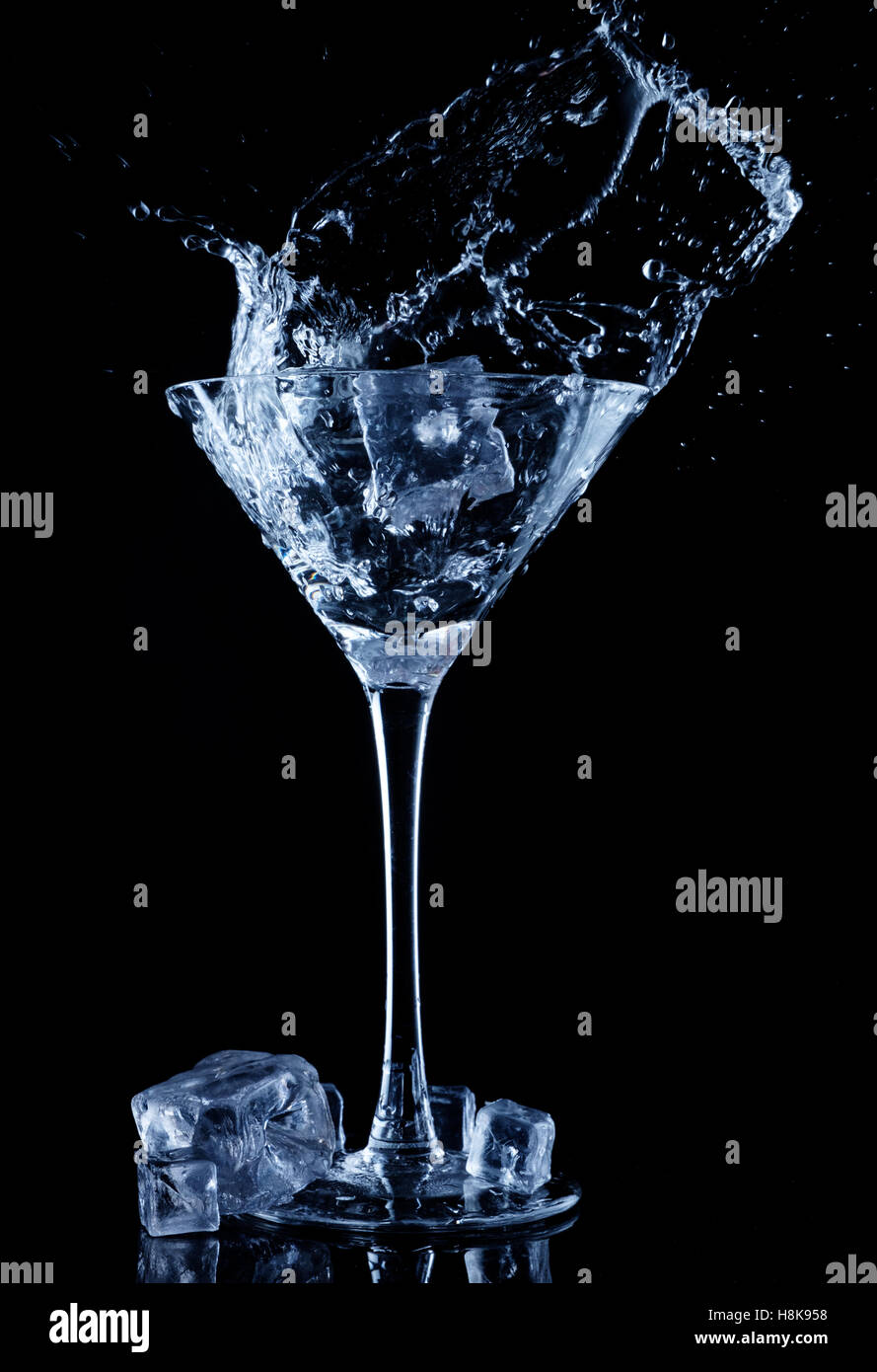 Water splash in glass with ice cubes Stock Photo - Alamy