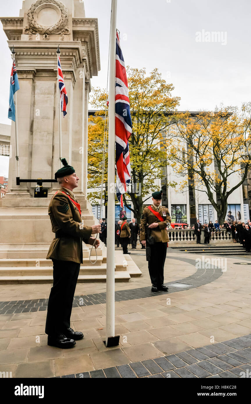 Belfast, Northern, Ireland. 13th Nov, 2016.A soldier lowers the Union Flag to half mast at the Remembrance Sunday service at Belfast City Hall Cenotaph. Credit:  Stephen Barnes/Alamy Live News Stock Photo