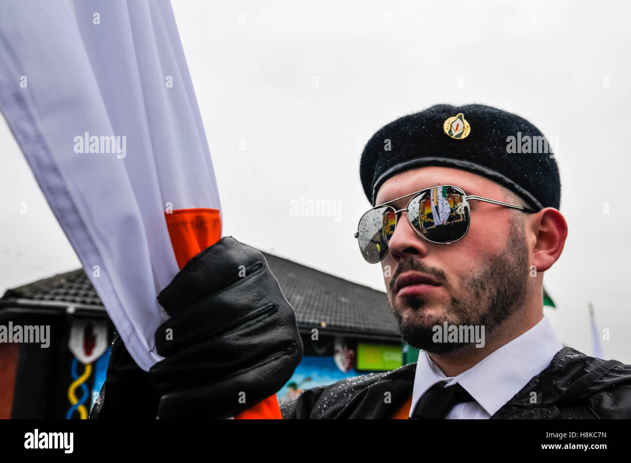 Belfast, Northern, Ireland. 13th Nov, 2016. A republican mural is reflected in the mirrored sunglasses of the main flagbearer at a Republican parade in remembrance of Vol. Patricia Black, who died 15 Nov 1991. Credit:  Stephen Barnes/Alamy Live News Stock Photo