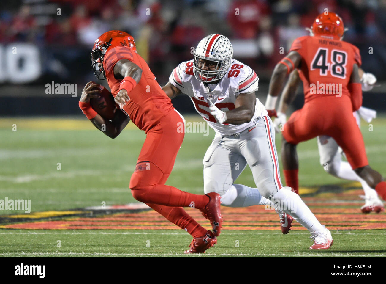 College Park, Maryland, USA. 12th Nov, 2016. Ohio State Buckeyes defensive end TYQUAN LEWIS (59) tries to tackle Maryland Terrapins quarterback TYRELL PIGROME (3) during a game played at Maryland Stadium at College Park, MD. Ohio State beat Maryland 62-3. © Ken Inness/ZUMA Wire/Alamy Live News Stock Photo