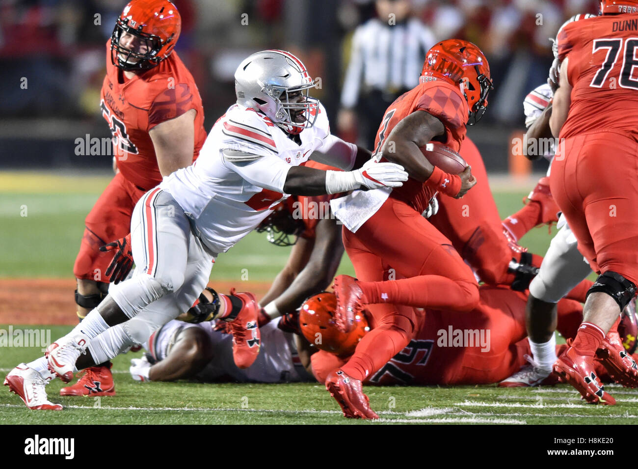 College Park, Maryland, USA. 12th Nov, 2016. Ohio State Buckeyes defensive lineman ROBERT LANDERS (67) tries to wrap up Maryland Terrapins quarterback TYRELL PIGROME (3) during a game played at Maryland Stadium at College Park, MD. Ohio State beat Maryland 62-3. © Ken Inness/ZUMA Wire/Alamy Live News Stock Photo