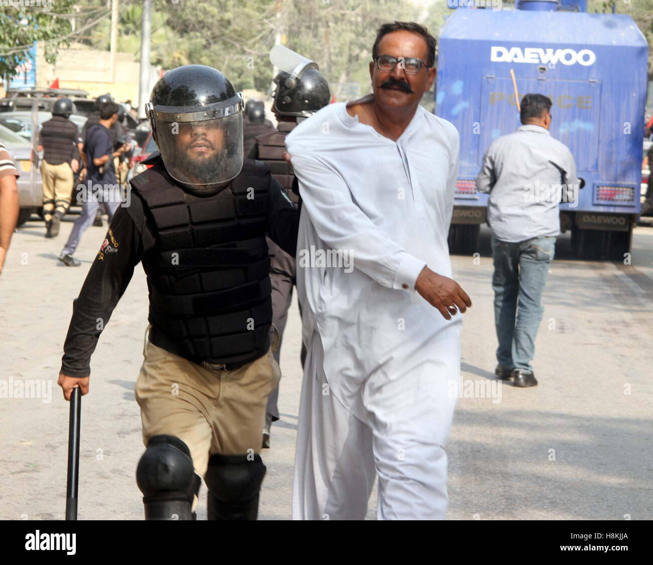 Police arresting protesters belonging to Irrigation Department of Sindh and were trying to get enter into Red Zone area, nearby Karachi press club on Monday, November 14, 2016 Stock Photo