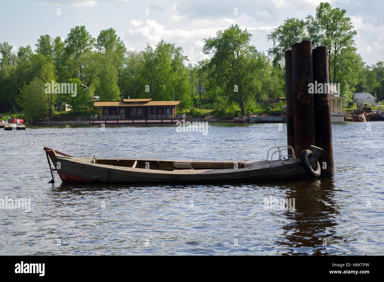 wooden rowboat, fishing boat on the river piers Stock Photo - Alamy