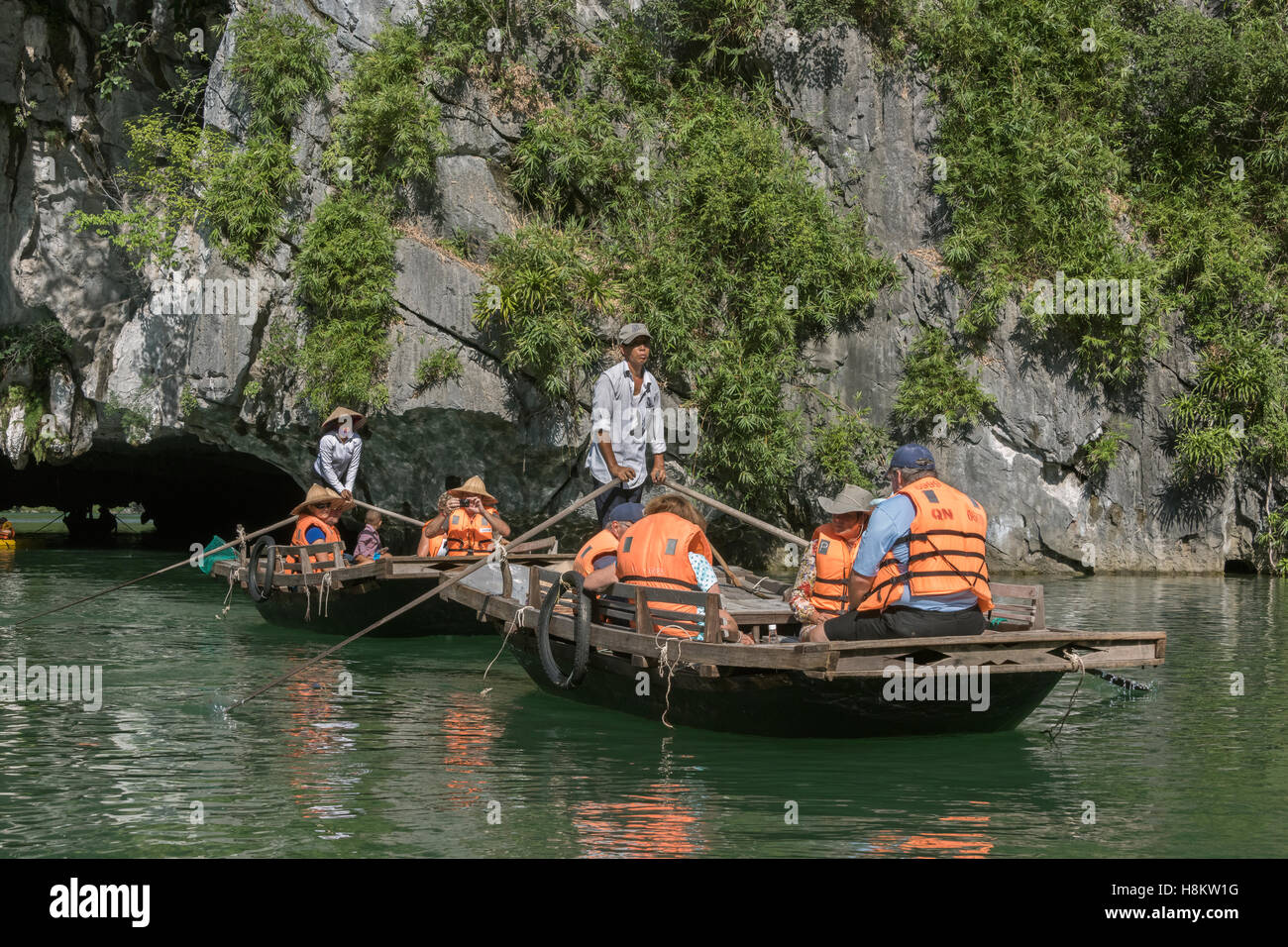 Tourist boats exiting Luon Cave in Ha Long Bay, north Vietnam Stock Photo