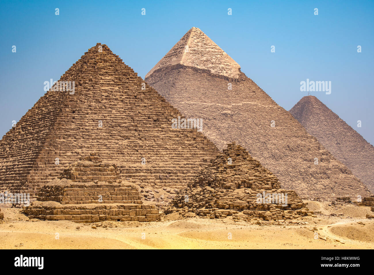 Cairo, Egypt The three Great pyramids of Giza against a clear blue sky. From left to right stands the Pyramid of Mekaure (smalle Stock Photo