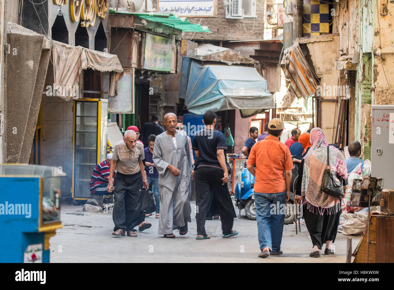 Cairo, Egypt. Locals walking through shops along an alleyway in the outdoor bazaar/ flea market Khan el-Khalili in Cairo. Stock Photo