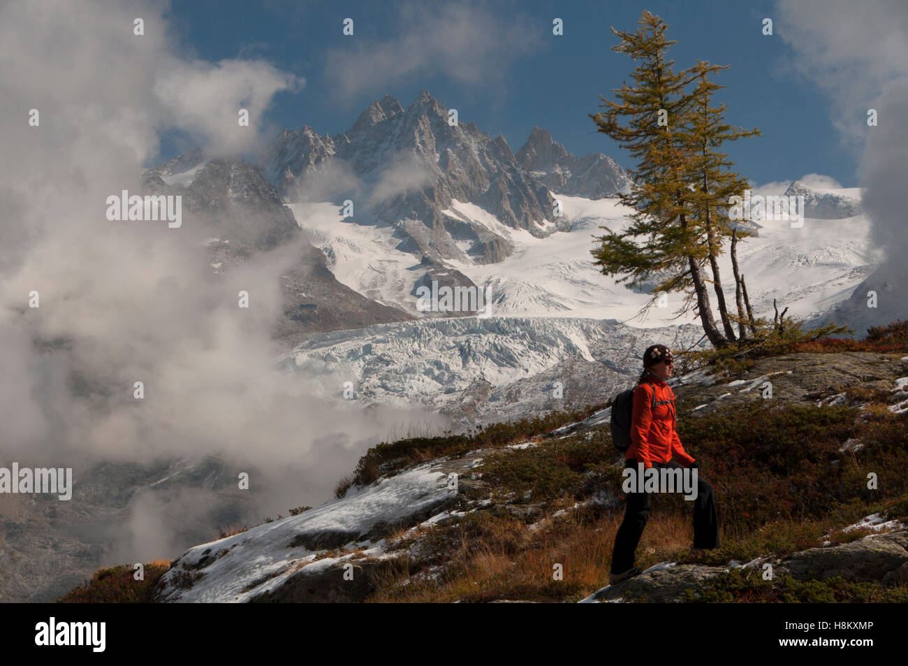 Woman hiking in the French Alps, Reserve Naturelle Nationale des Aiguilles Rouges, Chamonix-Mont-Blanc, France Stock Photo