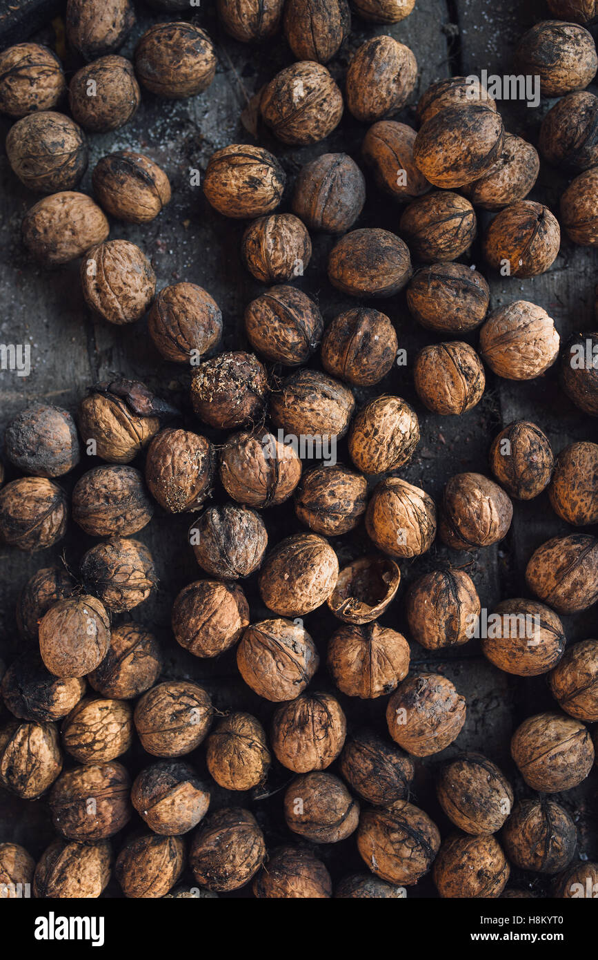 Pile of dry walnuts in shell on the table, top view Stock Photo