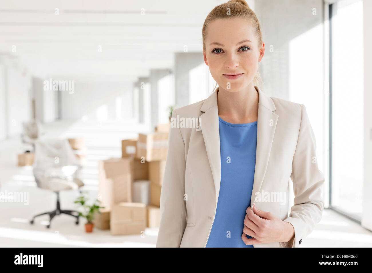 Portrait of beautiful young businesswoman in new office Stock Photo - Alamy