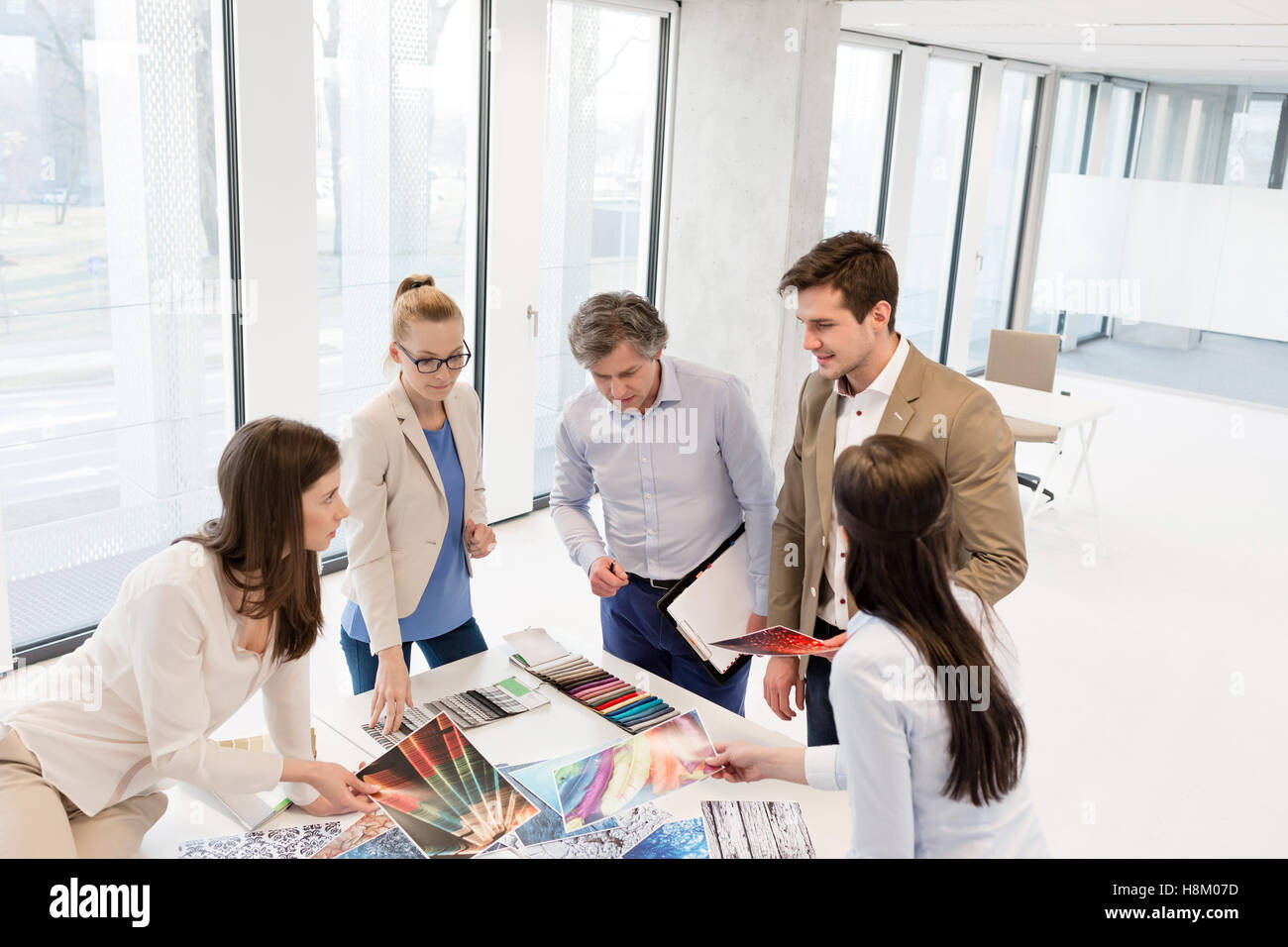 High angle view of design professionals having discussion at table in new office Stock Photo