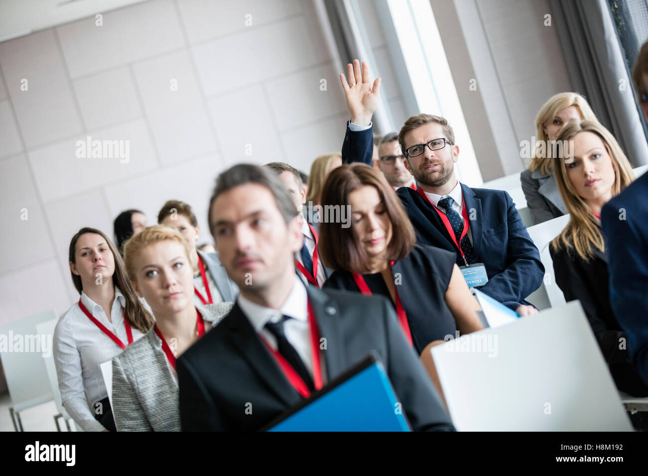 Business person raising hand meeting hi-res stock photography and ...
