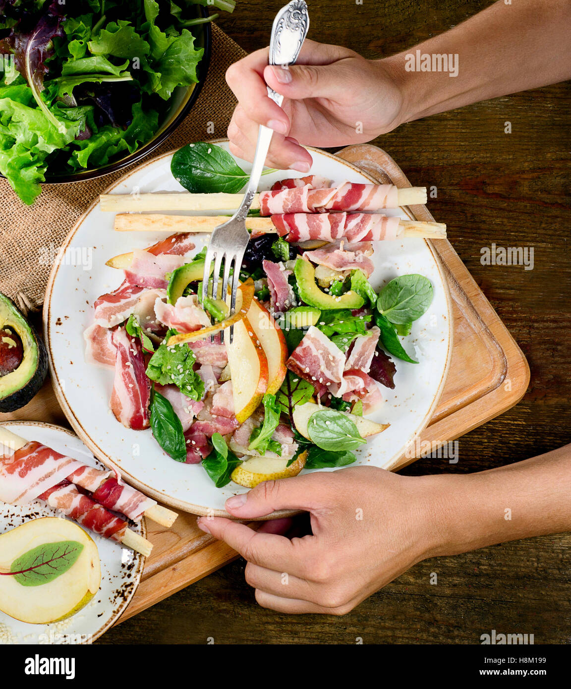 Woman hands with fresh salad. Top view Stock Photo