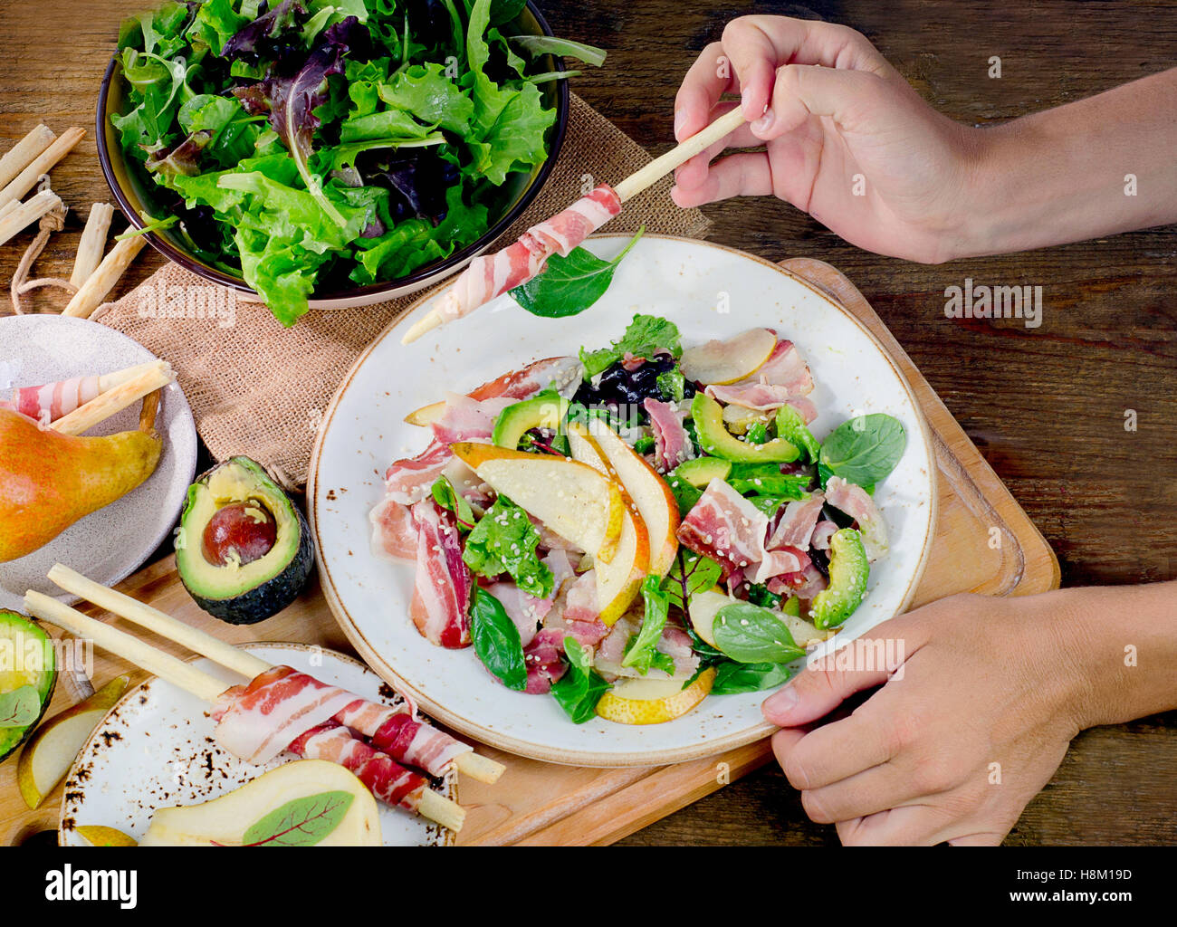 Woman hands with a fresh salad. Top view Stock Photo