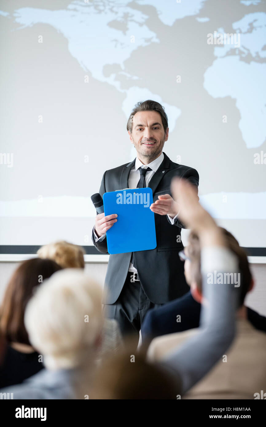 Public speaker asking questions to audience during seminar Stock Photo