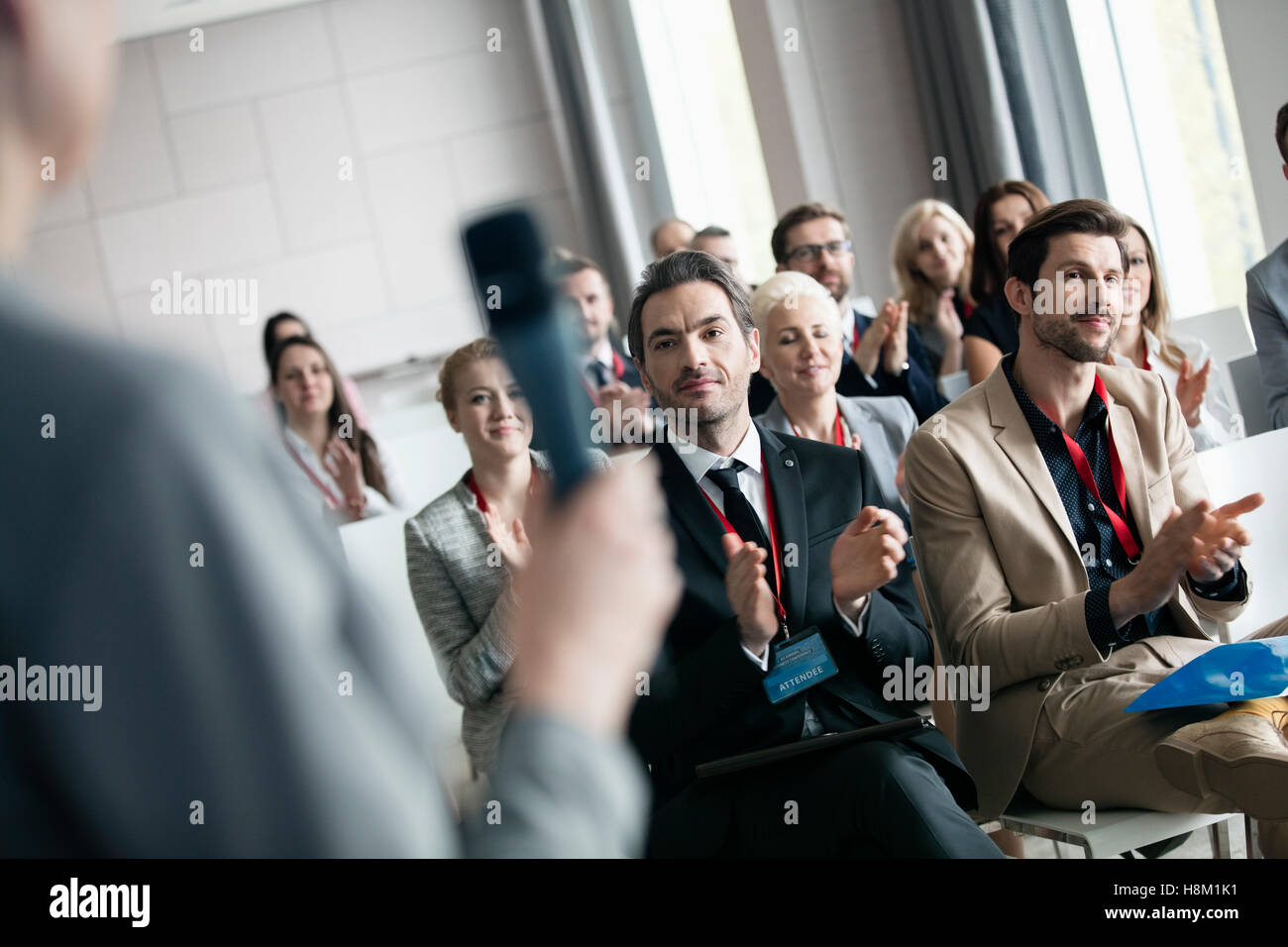 Business people applauding for public speaker during seminar Stock Photo