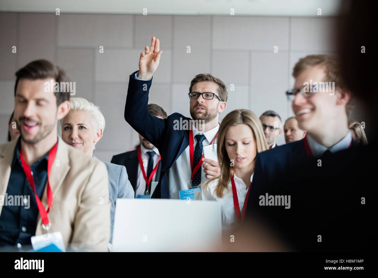 Businessman asking questions during seminar Stock Photo