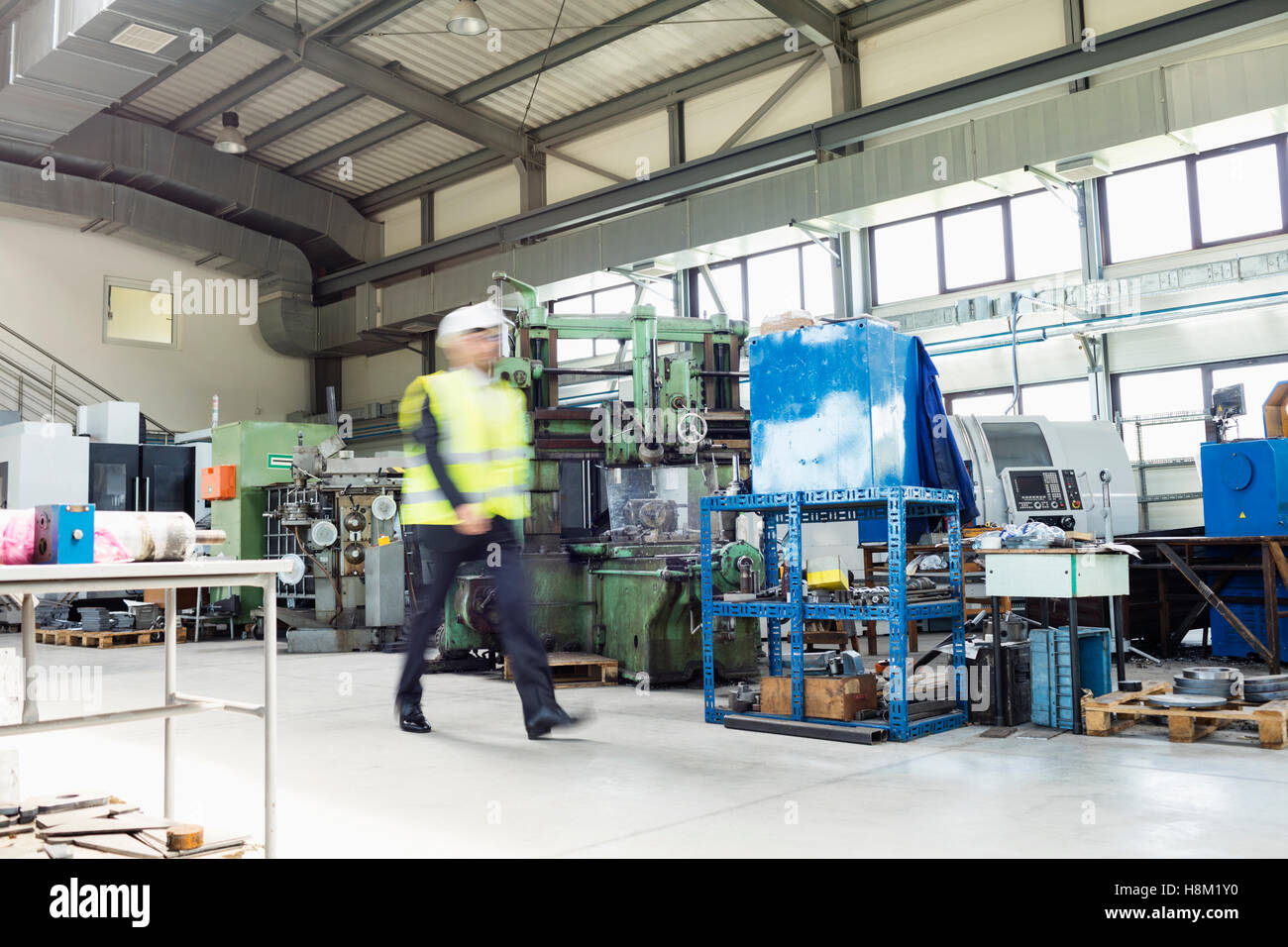 Blurred motion of male supervisor walking in metal industry Stock Photo