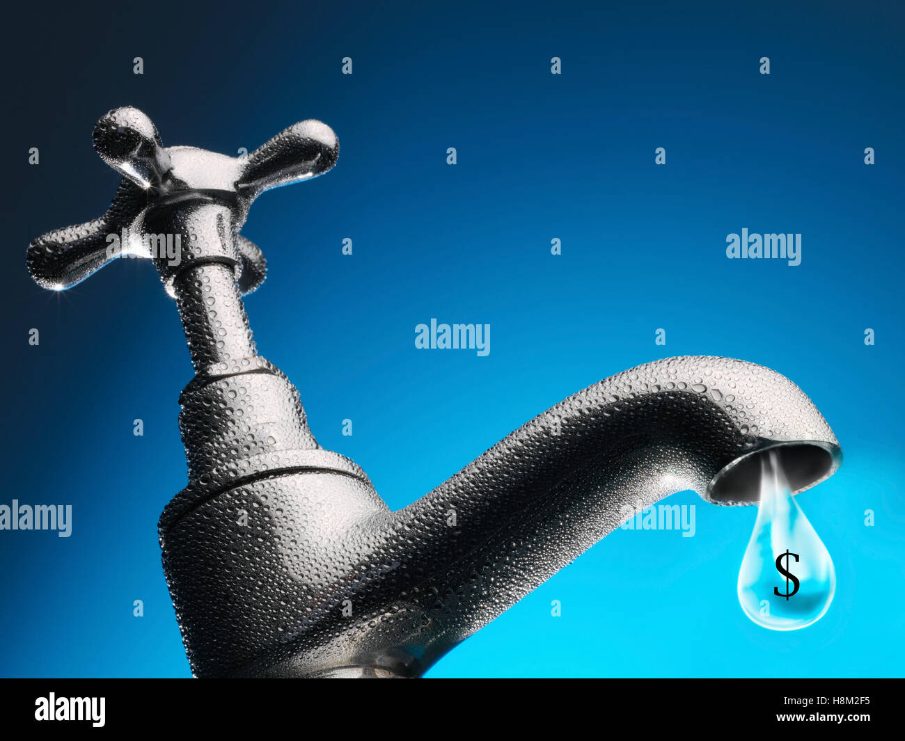 Drop of water trickling from tap close-up Stock Photo