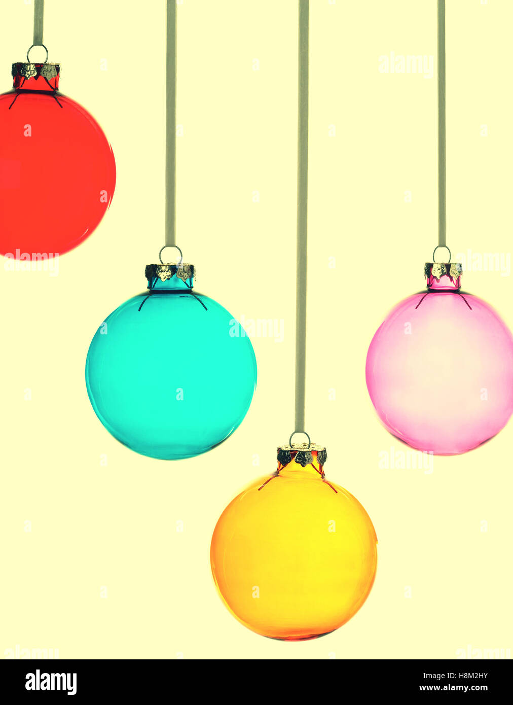 Four Christmas baubles on yellow vintage background Stock Photo