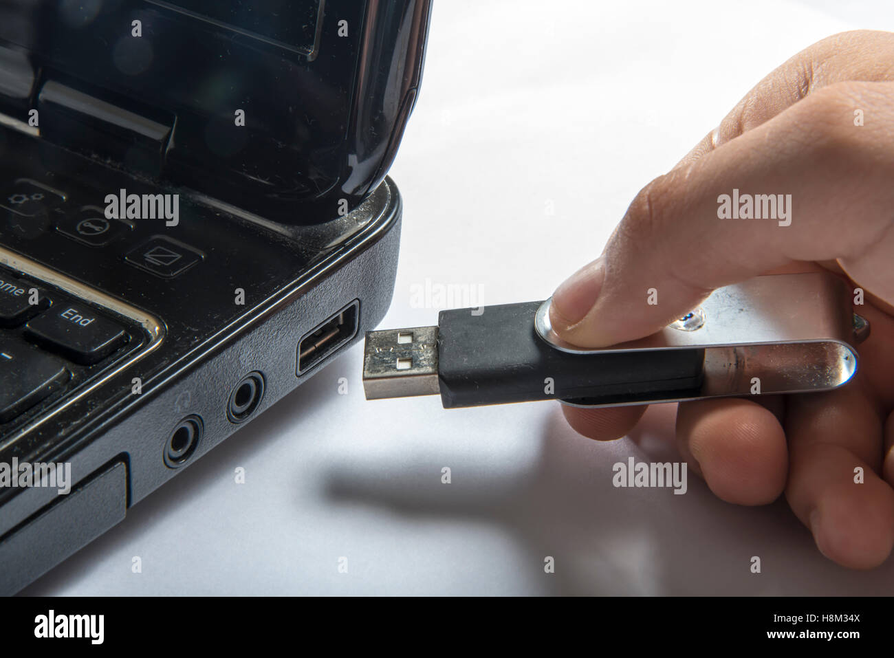 Hand inserting usb memory stick to laptop computer Stock Photo Alamy