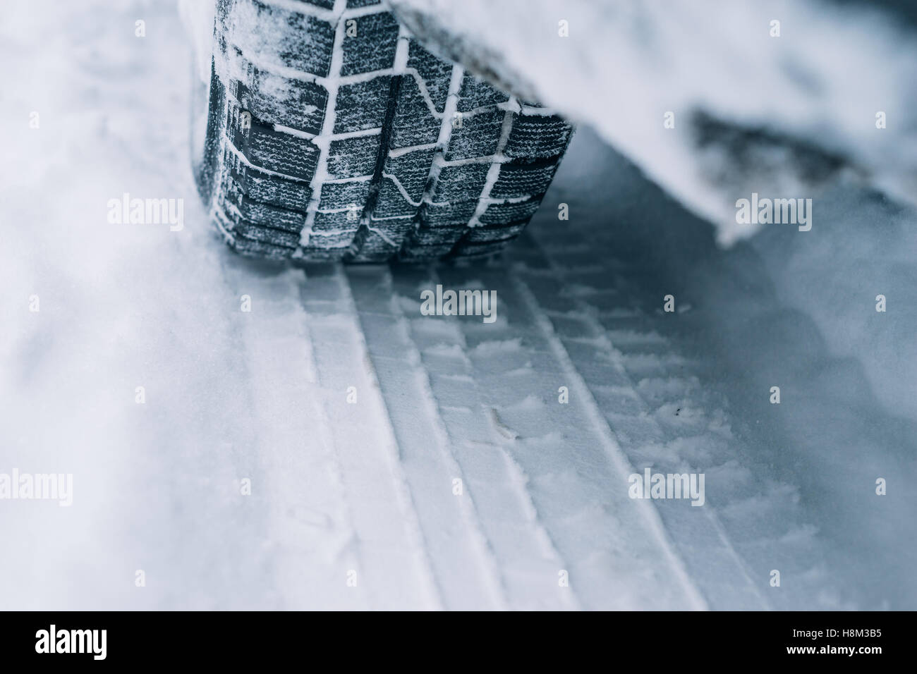 All-season tyre track on snow, winter tire concept Stock Photo