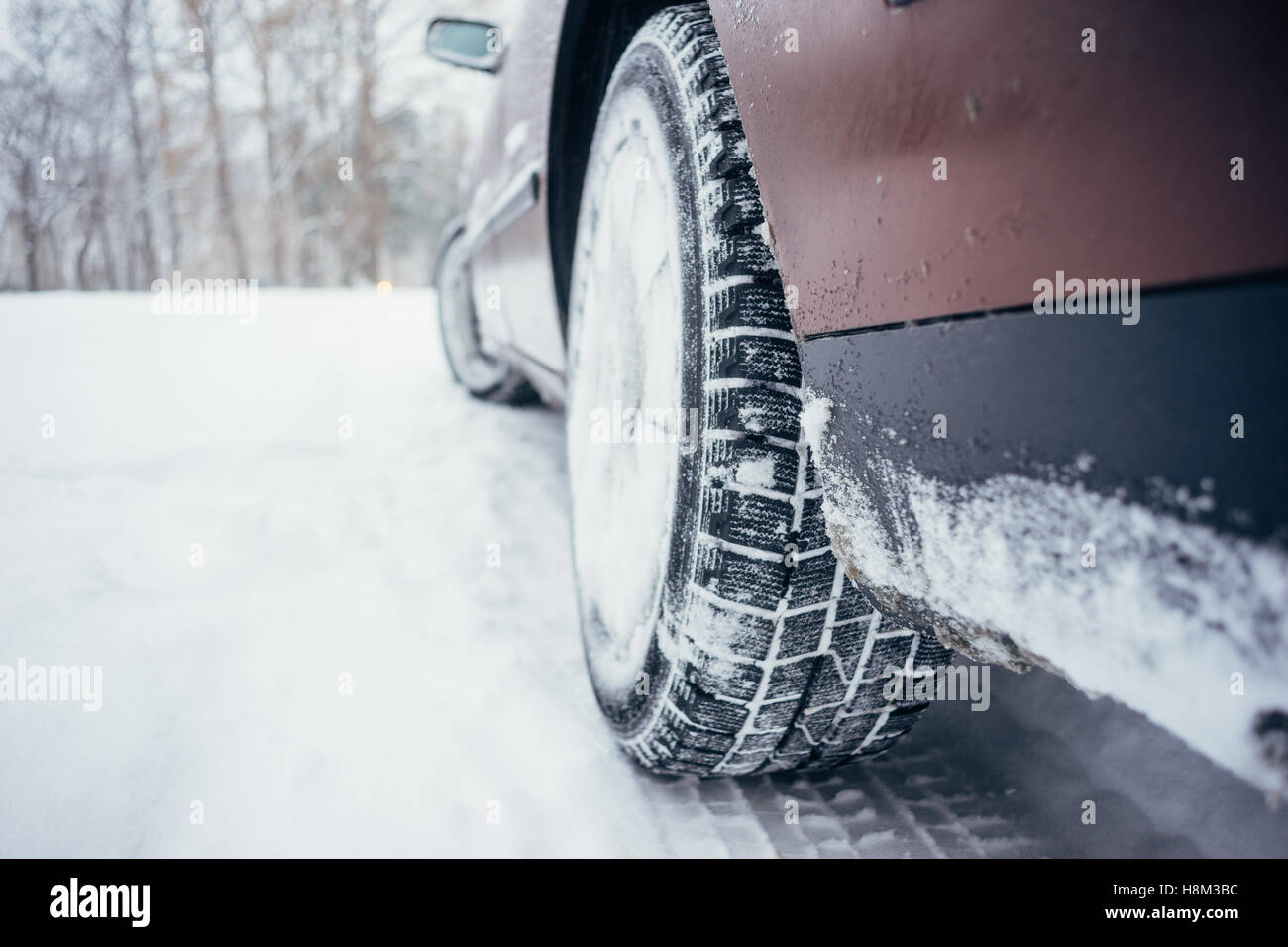 Car with winter tire on snowy road, defocused image Stock Photo