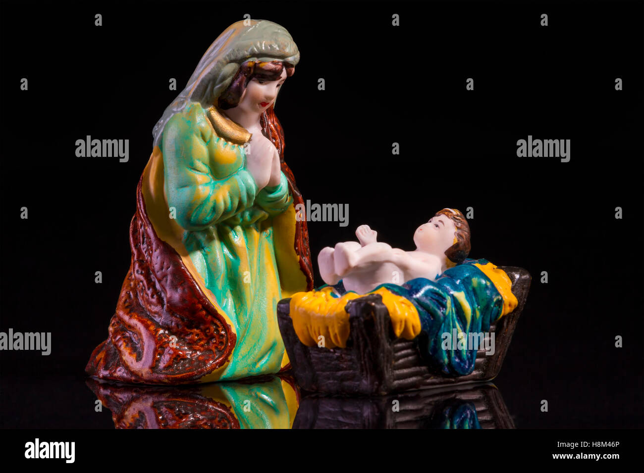 Christmas scene with Jesus and Mary on black background. Focus on Mary! Stock Photo
