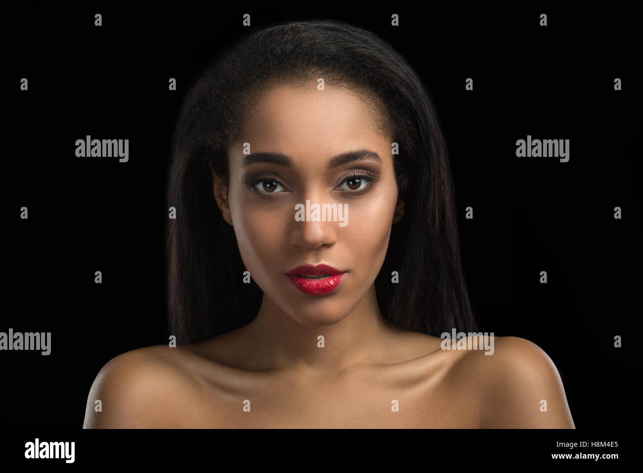 afro-amarican girl standing on dark background Stock Photo