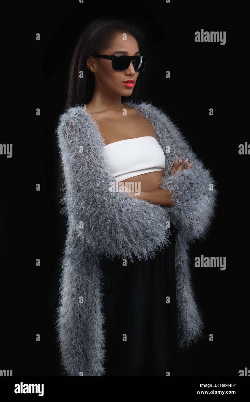 fashioned cute afro american woman standing in the dark. Stock Photo