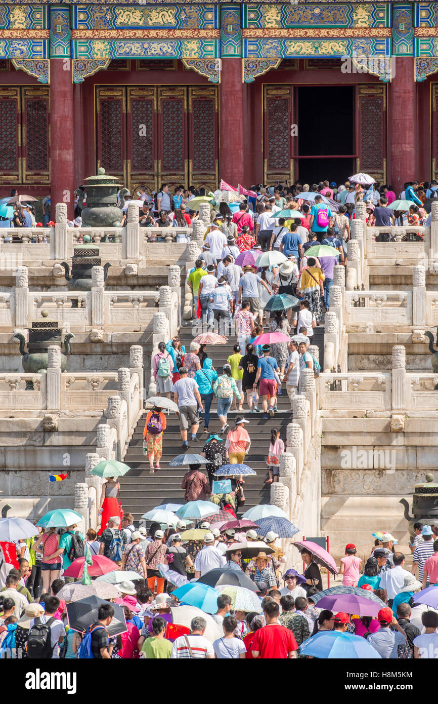 Beijing China - Tourists walking and taking pictures as they enter the Palace Museum located in the Forbidden City. Stock Photo