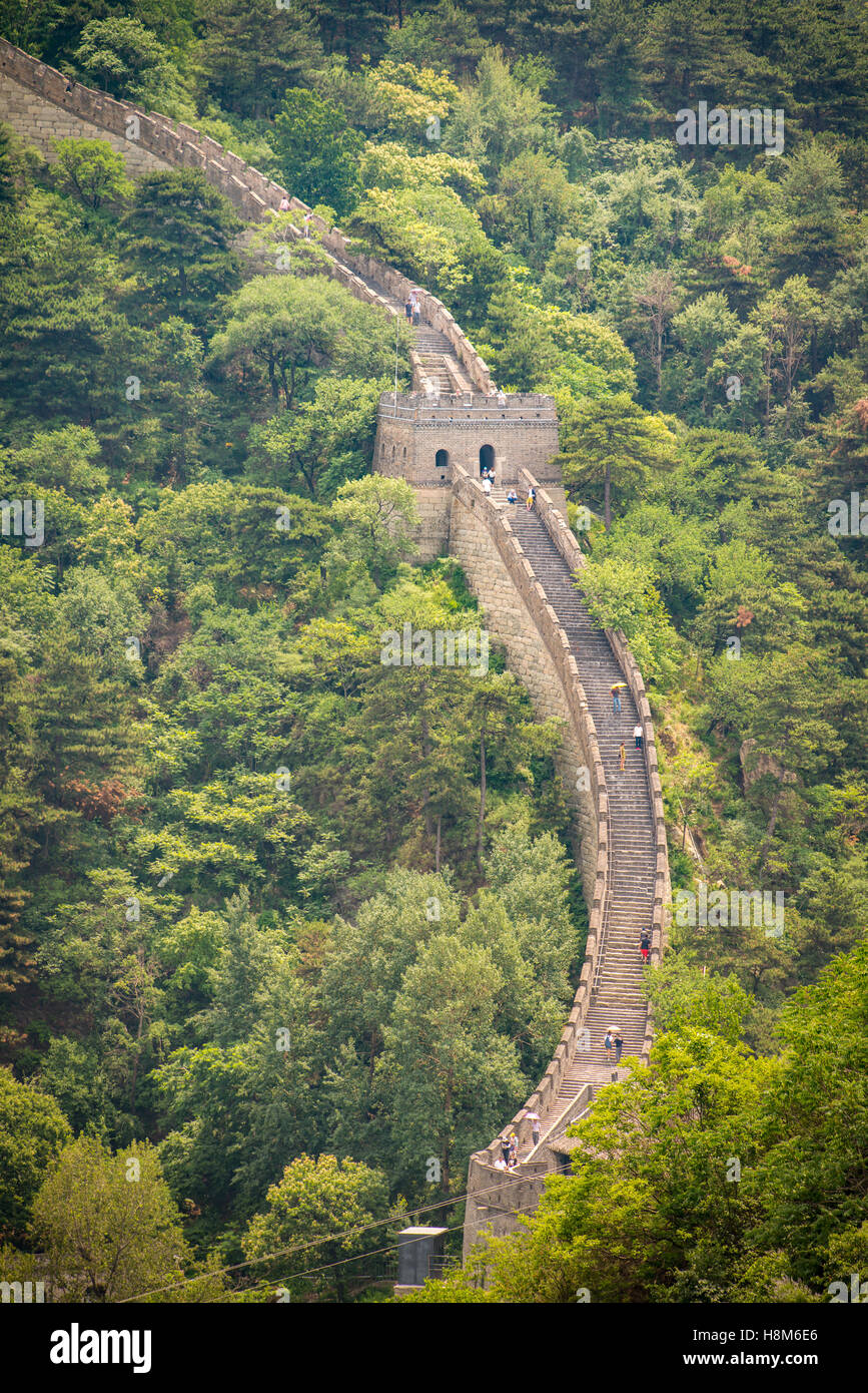 Mutianyu, China - Landscape view of tourists taking pictures and walking on the Great Wall of China. The wall stretches over 6,0 Stock Photo