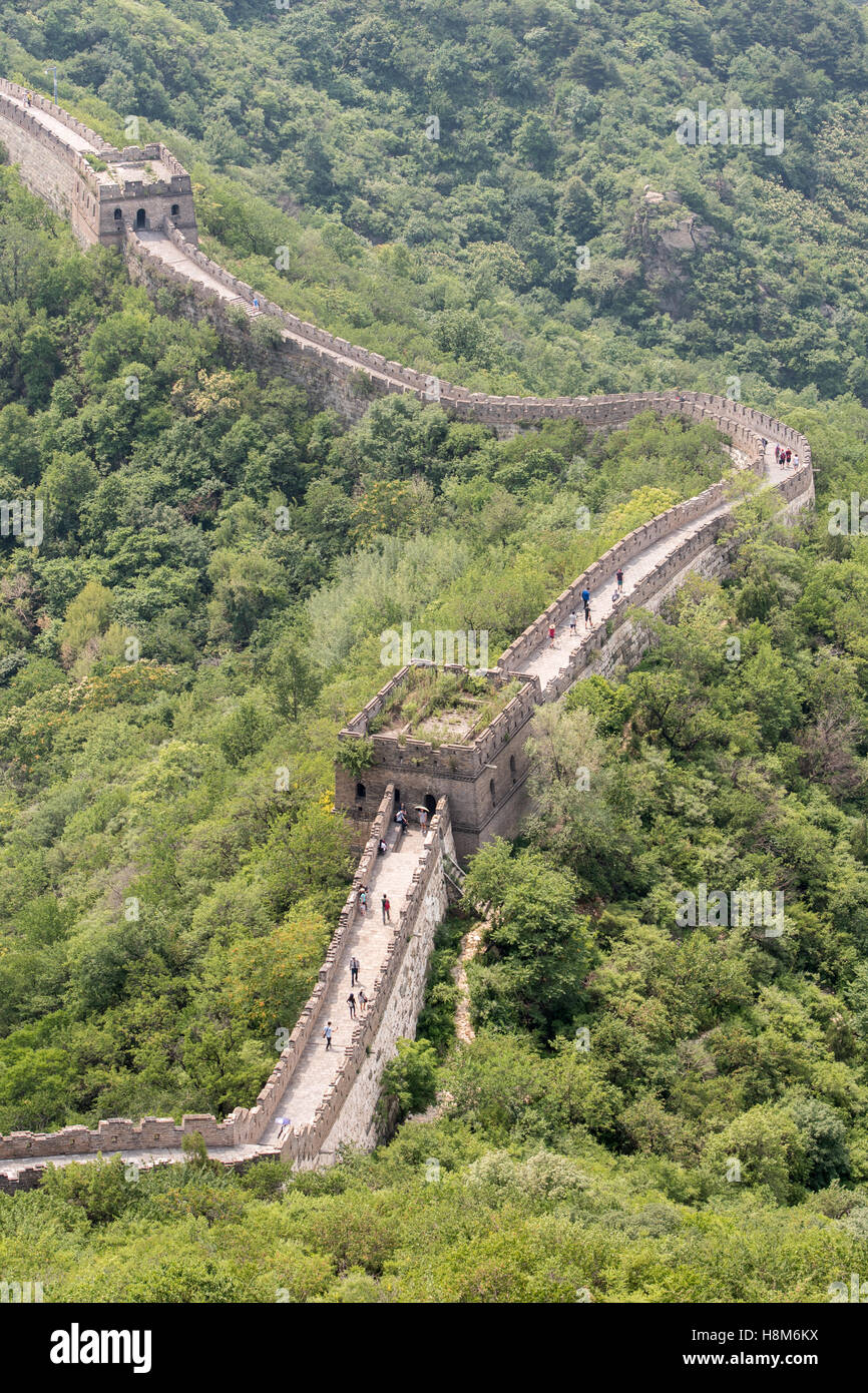 Mutianyu, China - Landscape view of tourists taking pictures and walking on the Great Wall of China. The wall stretches over 6,0 Stock Photo