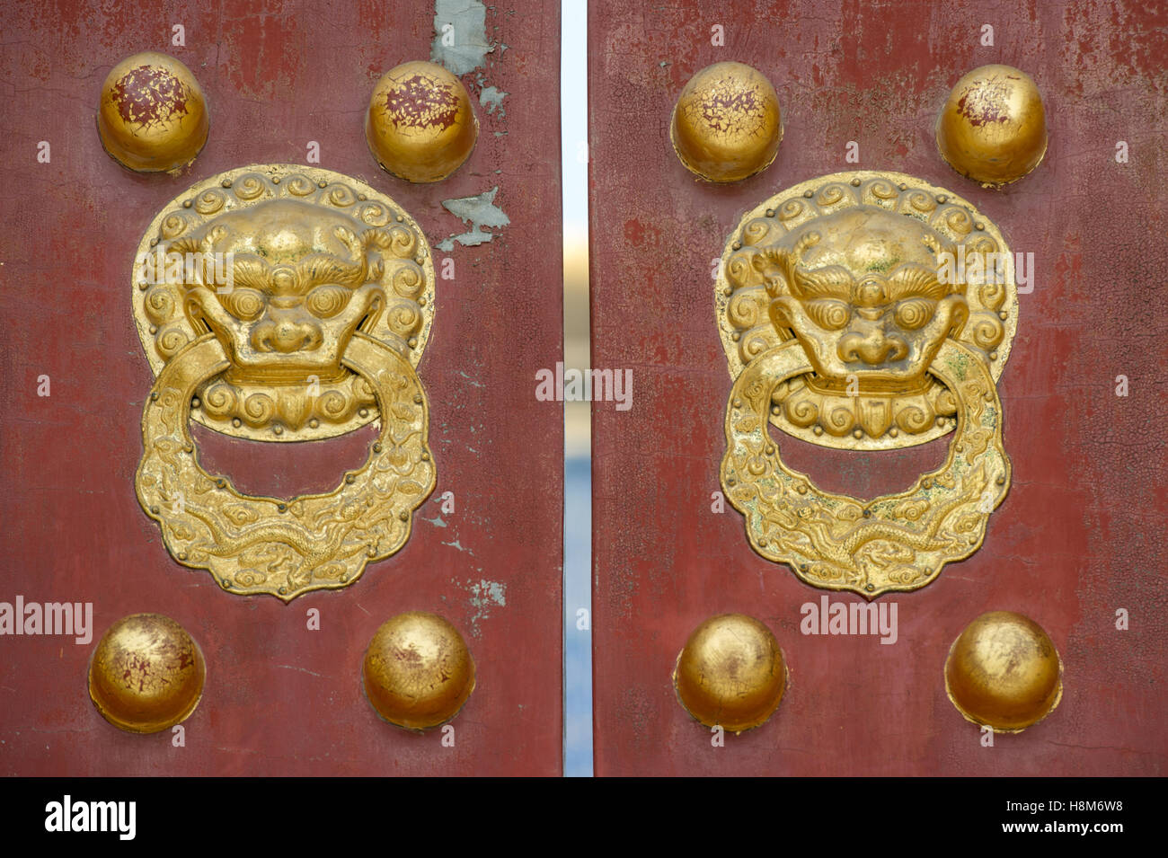 Beijing, China - Gold door knockers on the outside the gates of the Temple of Heaven, an imperial sacrificial altar located in C Stock Photo