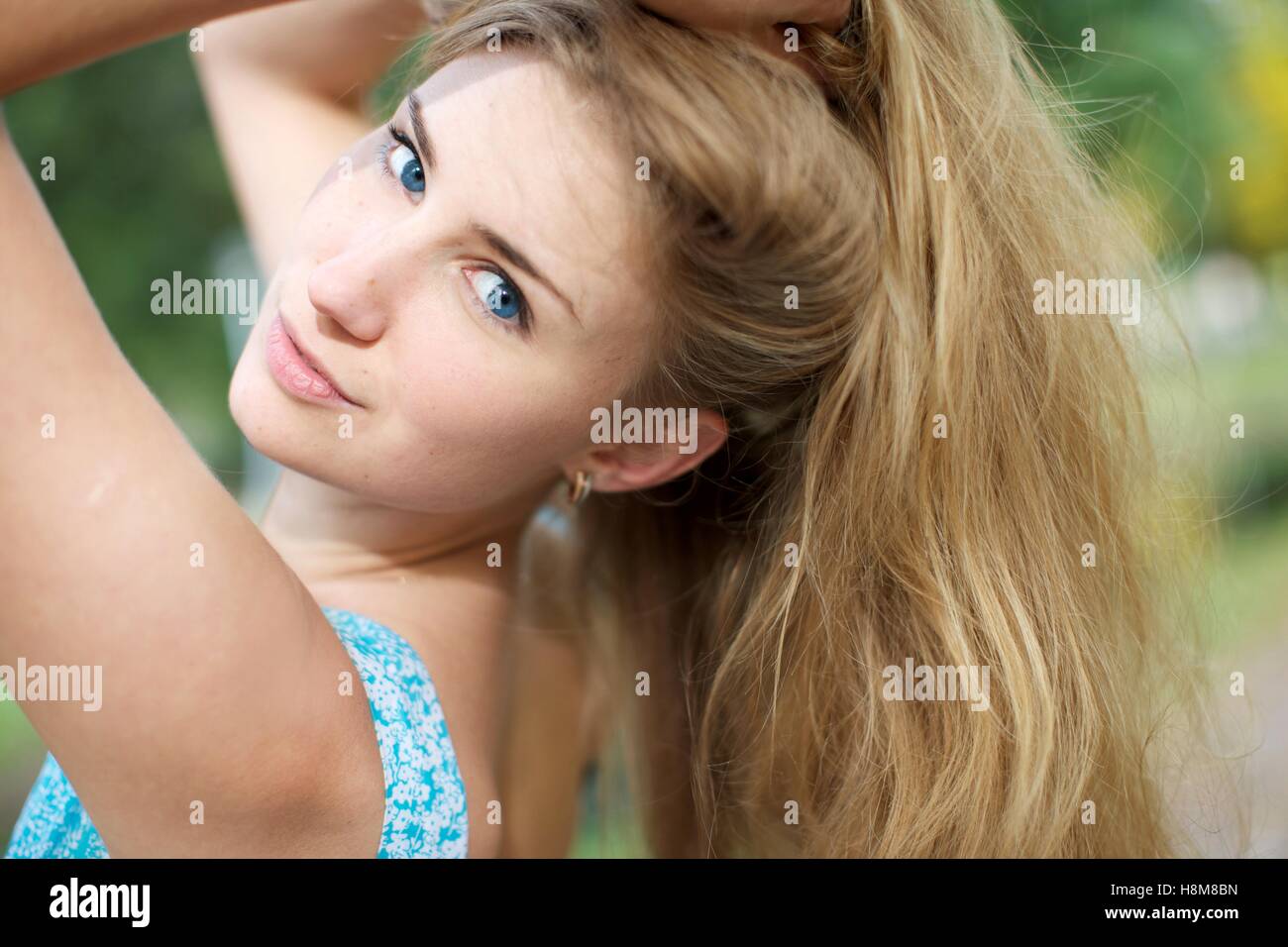 Closeup Blondie 23 year old in blue dress Stock Photo