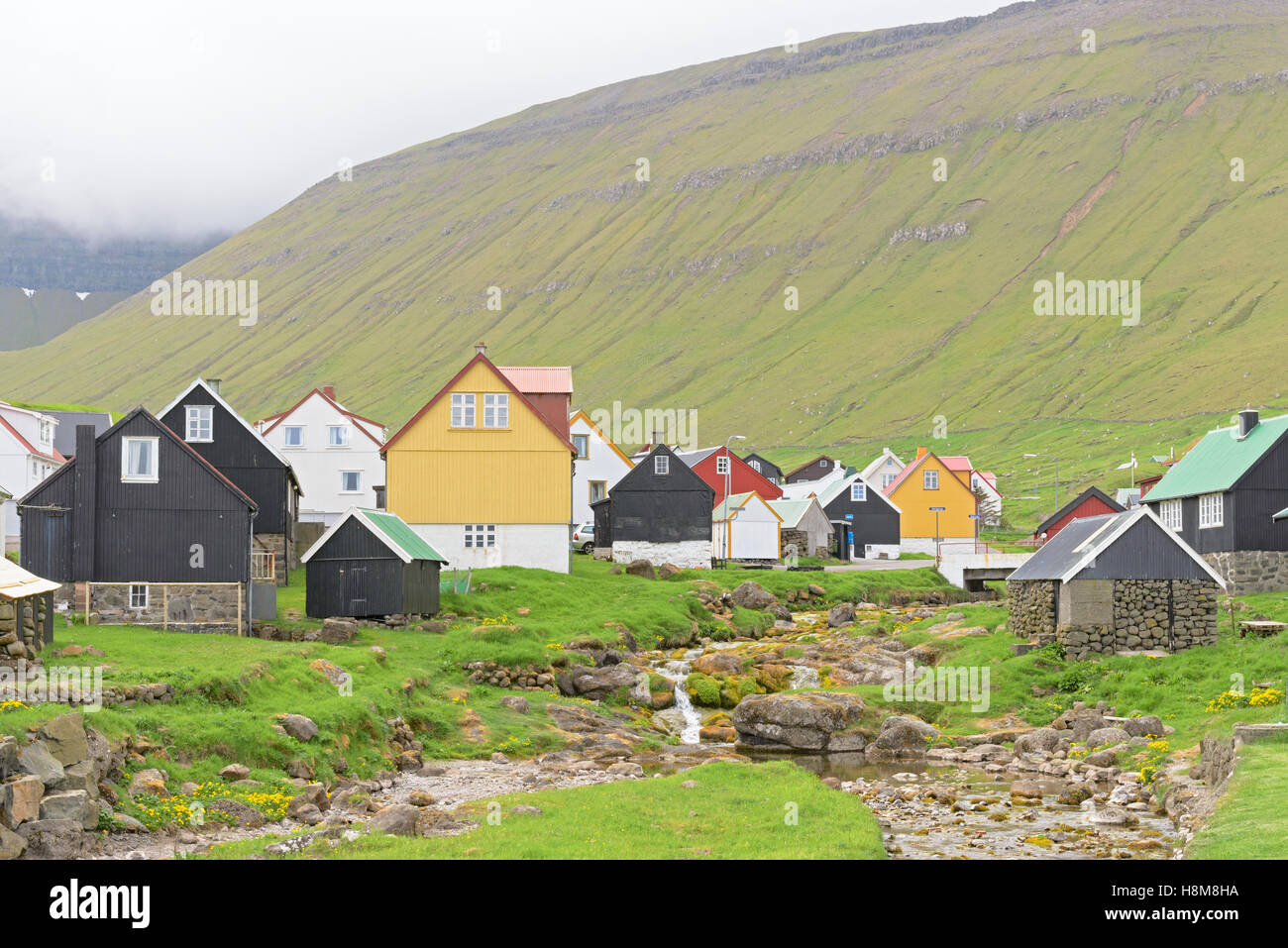 Picturesque village of Gjogv with typically colourful houses and the smaal creek on the island of Eysturoy, Faroe Islands Stock Photo