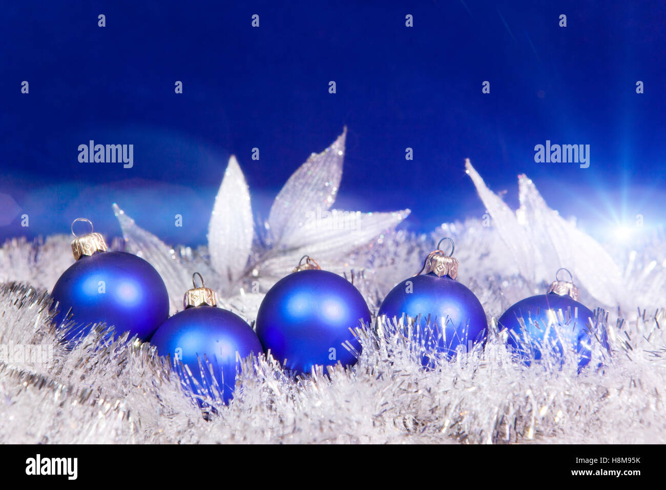 Blue New Year's balls and tinsel on a blue background Stock Photo