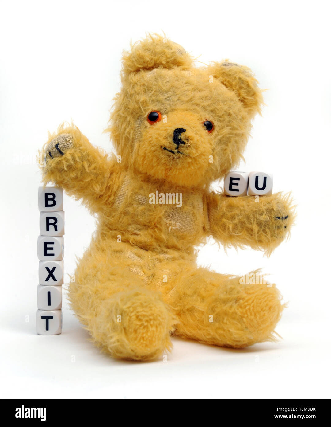 OLD TEDDY BEAR WITH WORD DICE SPELLING 'BREXIT' AND 'EU' RE BREXIT THE EU LEAVING REFERENDUM VOTE THE EUROPEAN UNION LEAVE GB UK Stock Photo