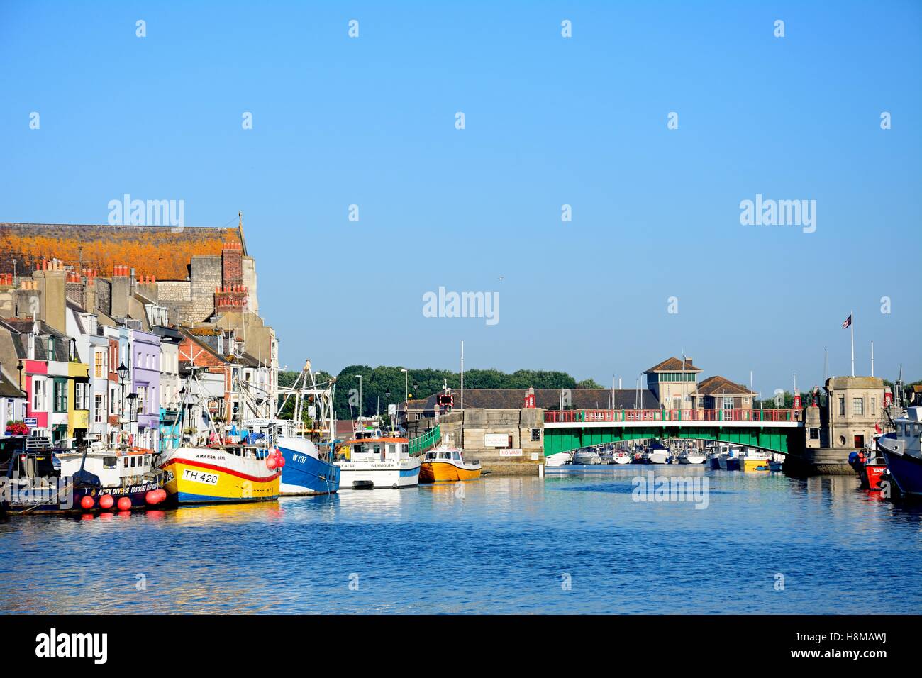 View of the twin leaf bascule bridge and fishing trawlers in the harbour, Weymouth, Dorset, England, UK, Western Europe. Stock Photo