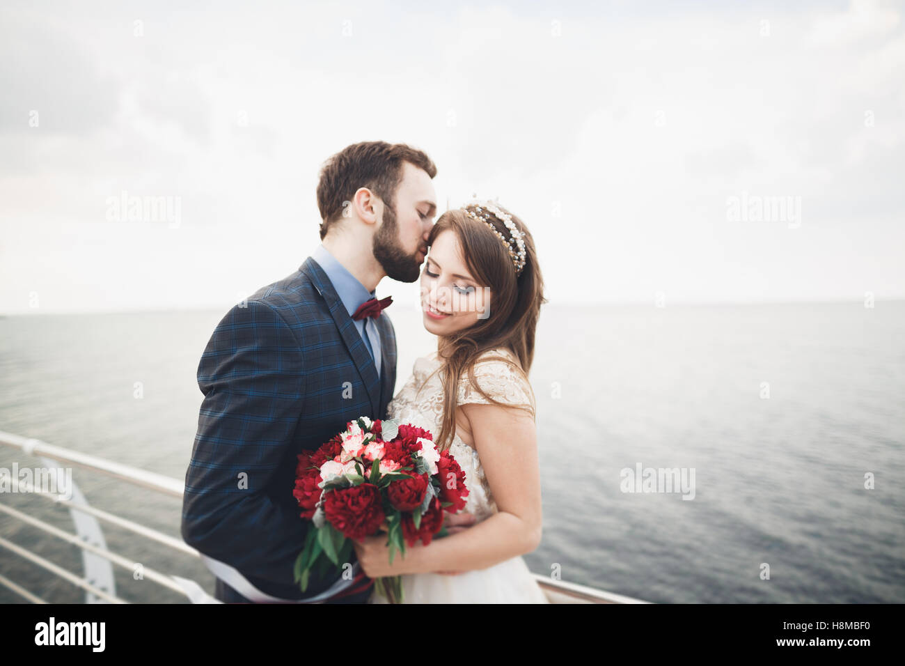 Just married wedding couple walking on the beach at sunset Stock Photo ...