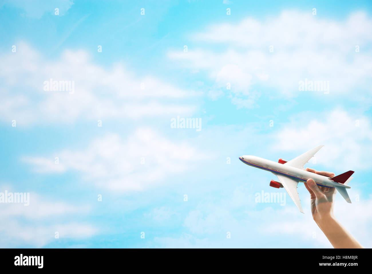 Toy Plane flying against clouds Stock Photo