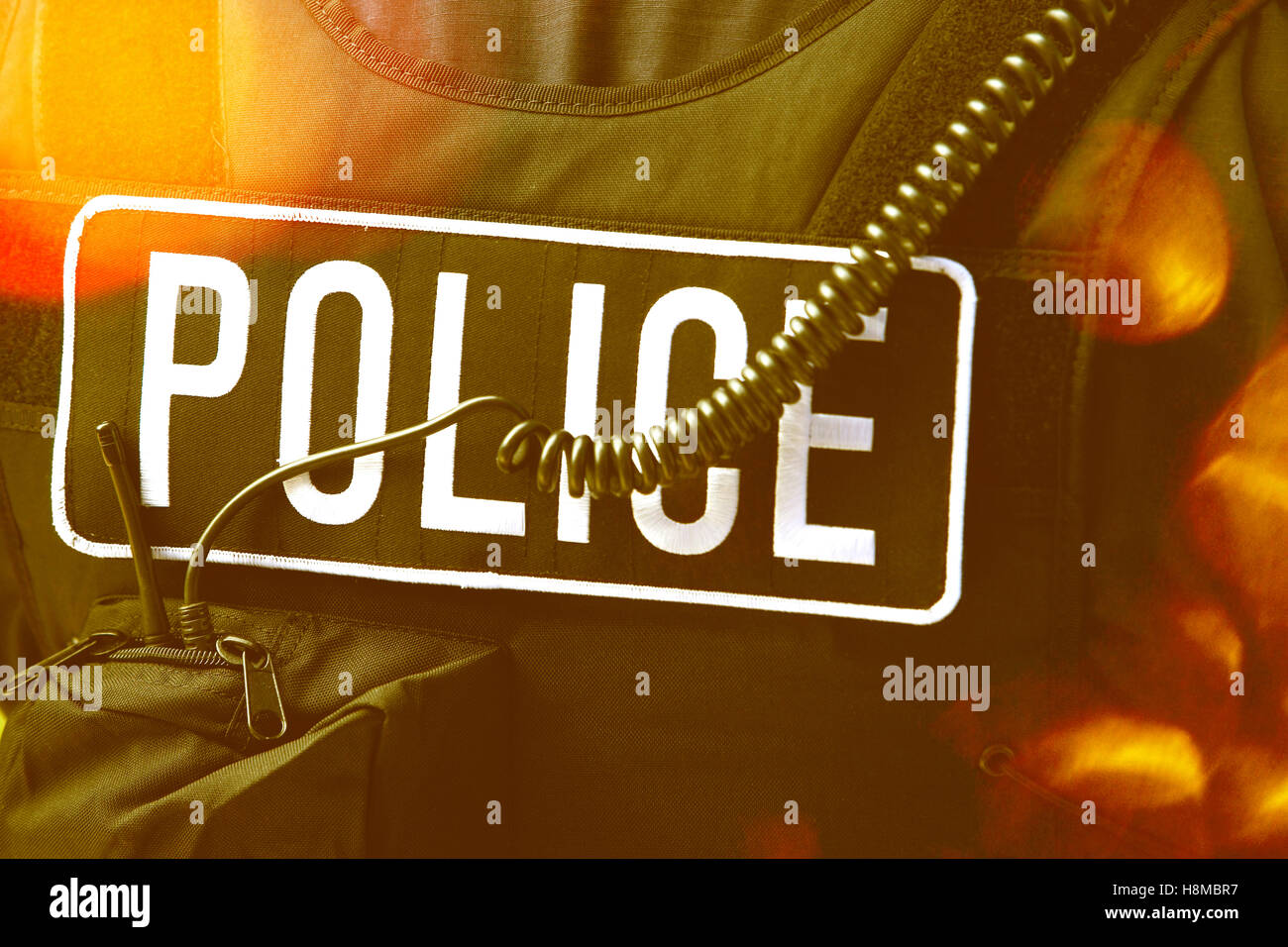 Closeup rear view of policeman's sign and cord on protective jacket Stock Photo