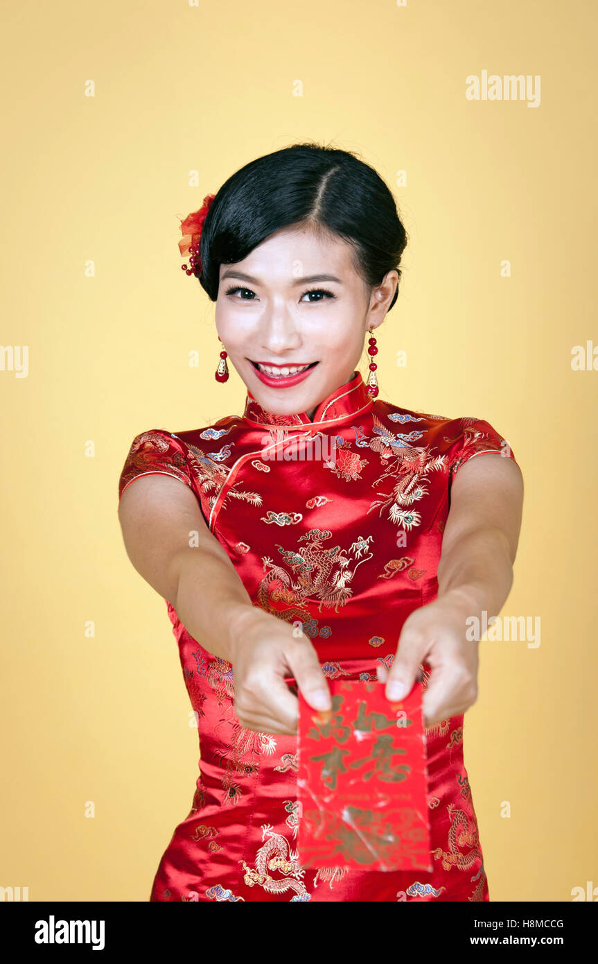 pretty chinese young woman holding red pocket for happy chinese new year Stock Photo