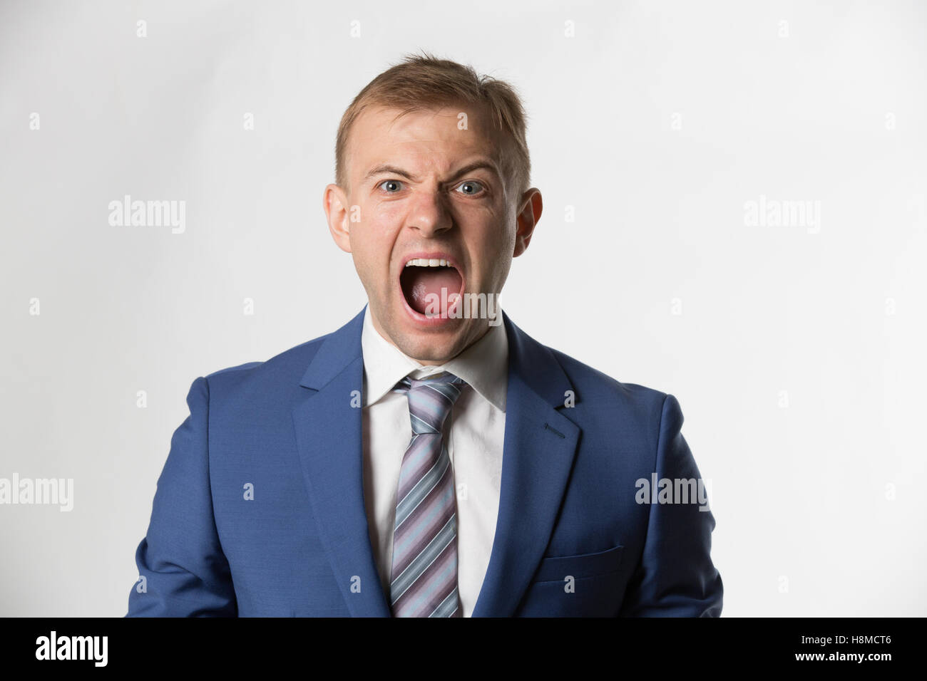 Angry Businessman screaming to camera Stock Photo