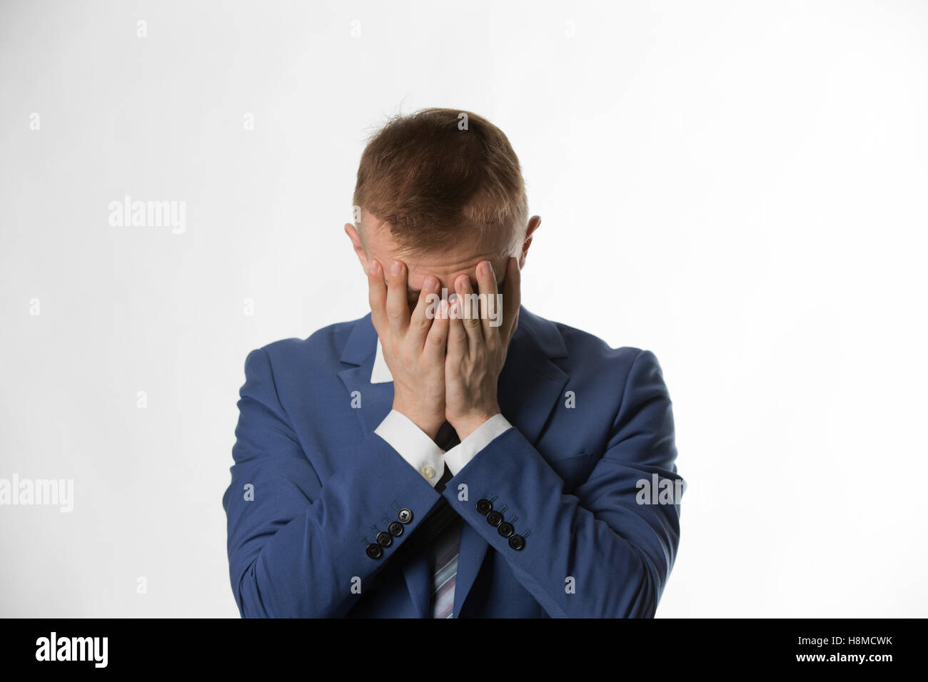 depressed businessman with holding his head in hands Stock Photo - Alamy