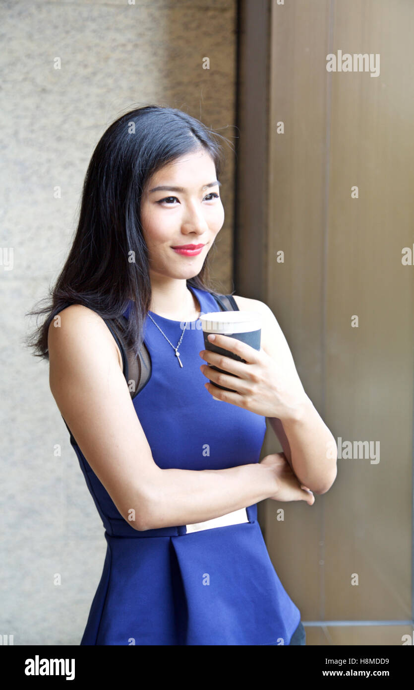Beautiful Chinese Businesswoman drinking coffee Stock Photo Alamy