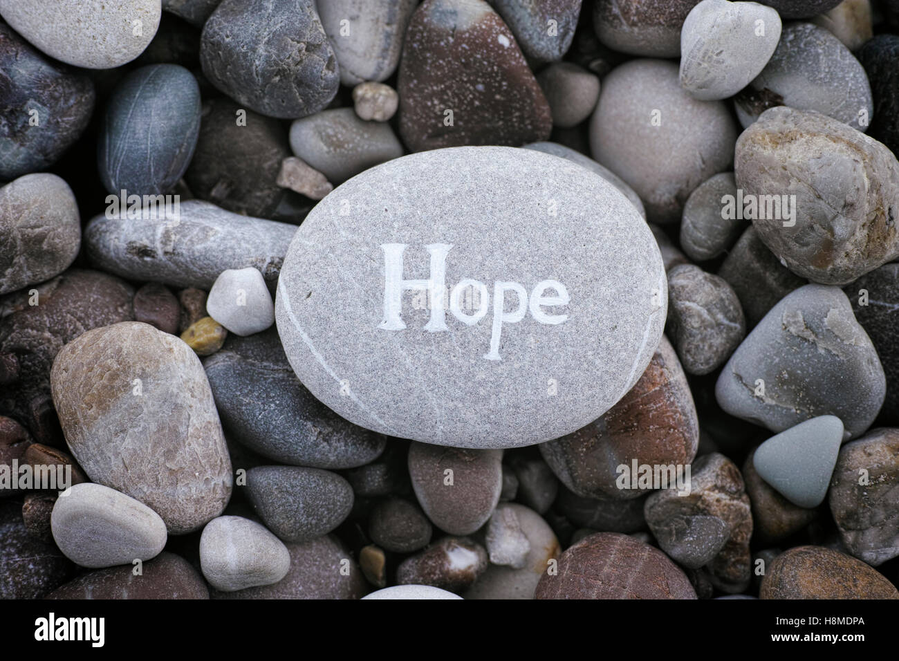 Hope. Stone with the word Hope on stone background. Close up. Stock Photo