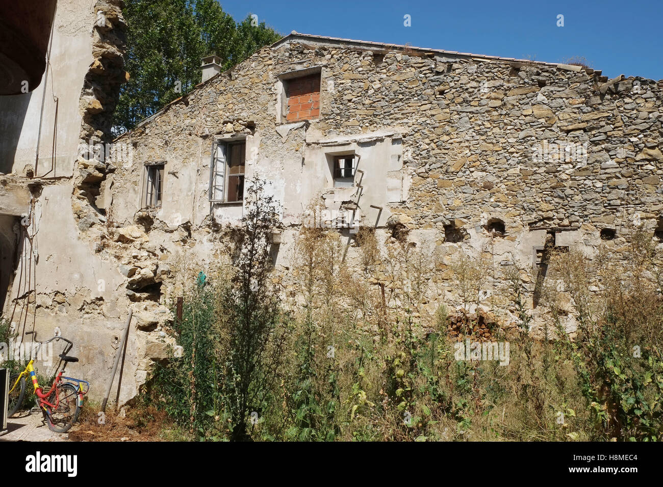 Old building of character left to decay of for possible development in the town of Olonzac in South West France Stock Photo