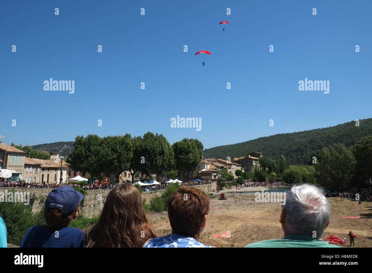 French army parachute display team lands on dry river bed in rural village in south west France Stock Photo