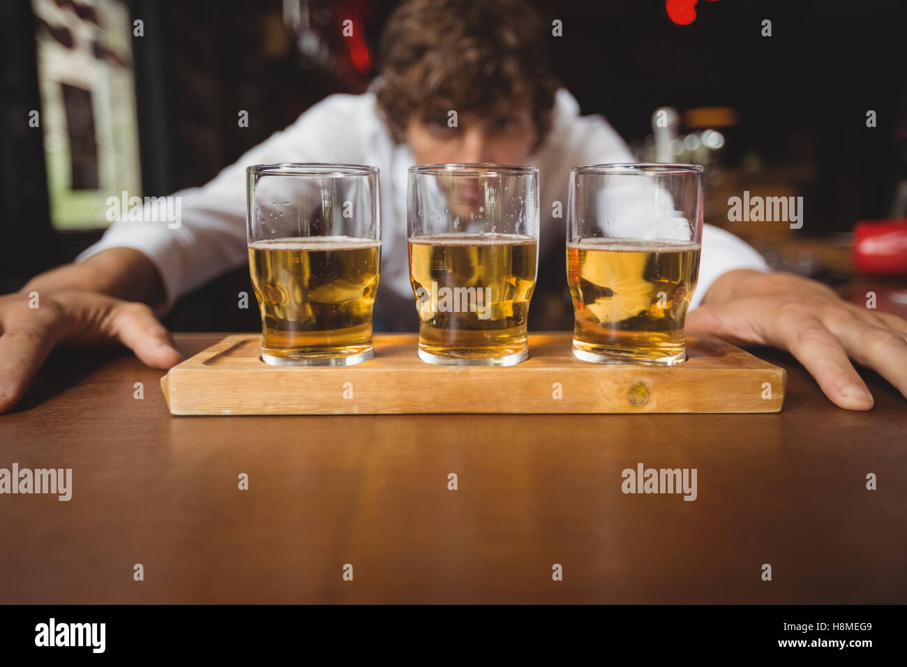 Bartender lining whisky shot glasses on bar counter Stock Photo Alamy